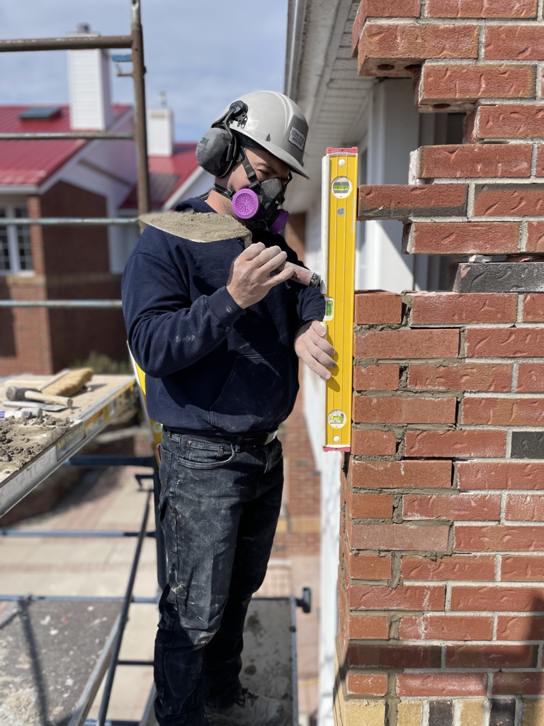 Stone Worx mason rebuilding a brick corner