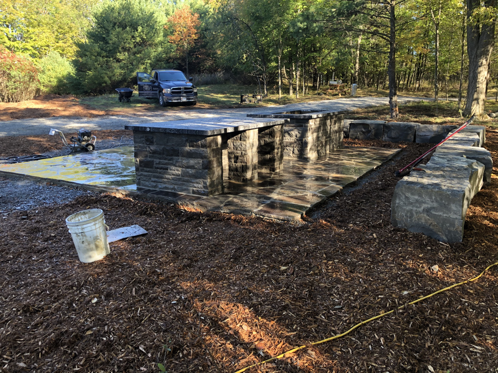 Custom outdoor stone kitchen, patio and seating walls