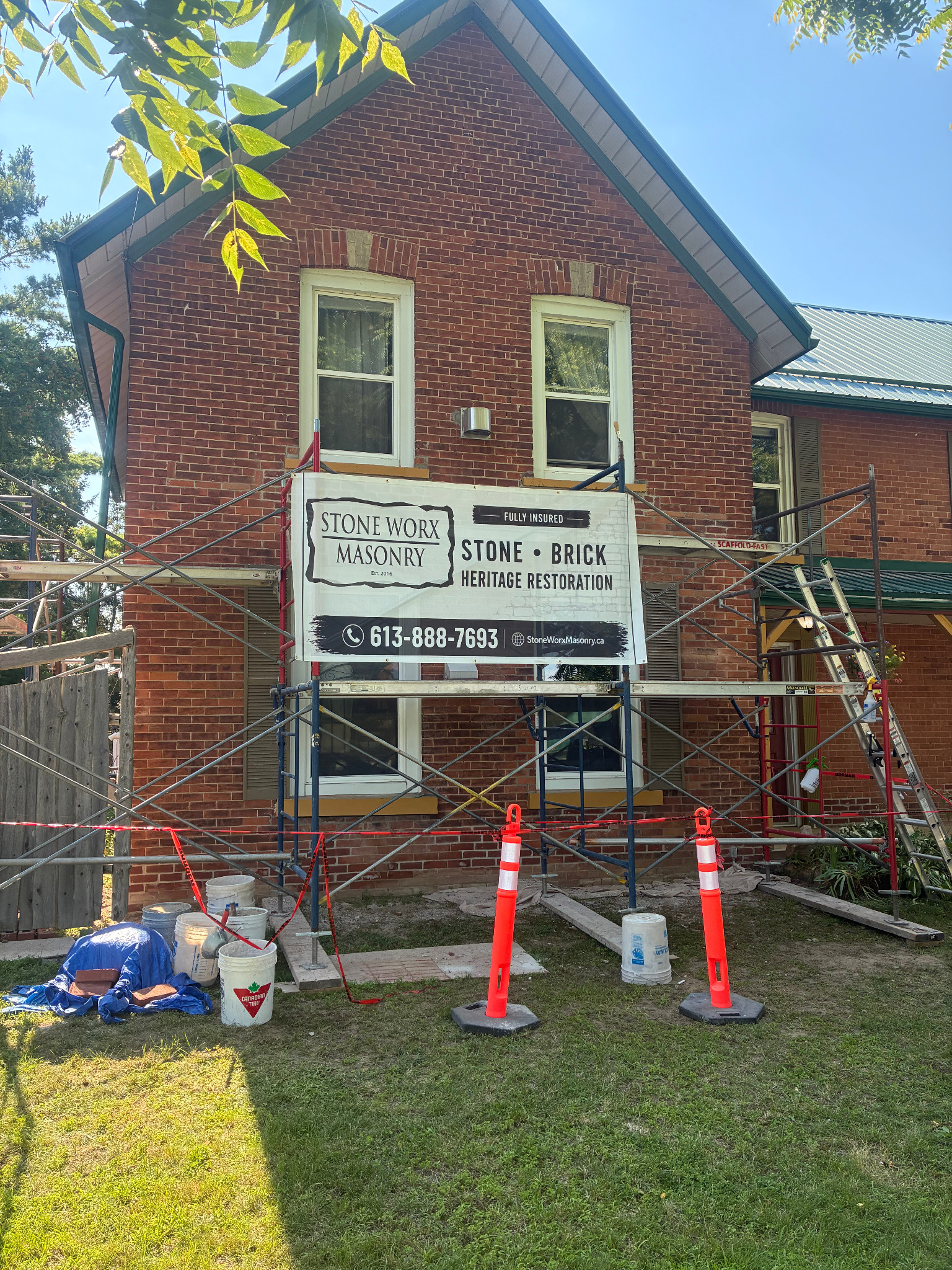 Stone Worx Masonry banner displayed on an active brick restoration jobsite